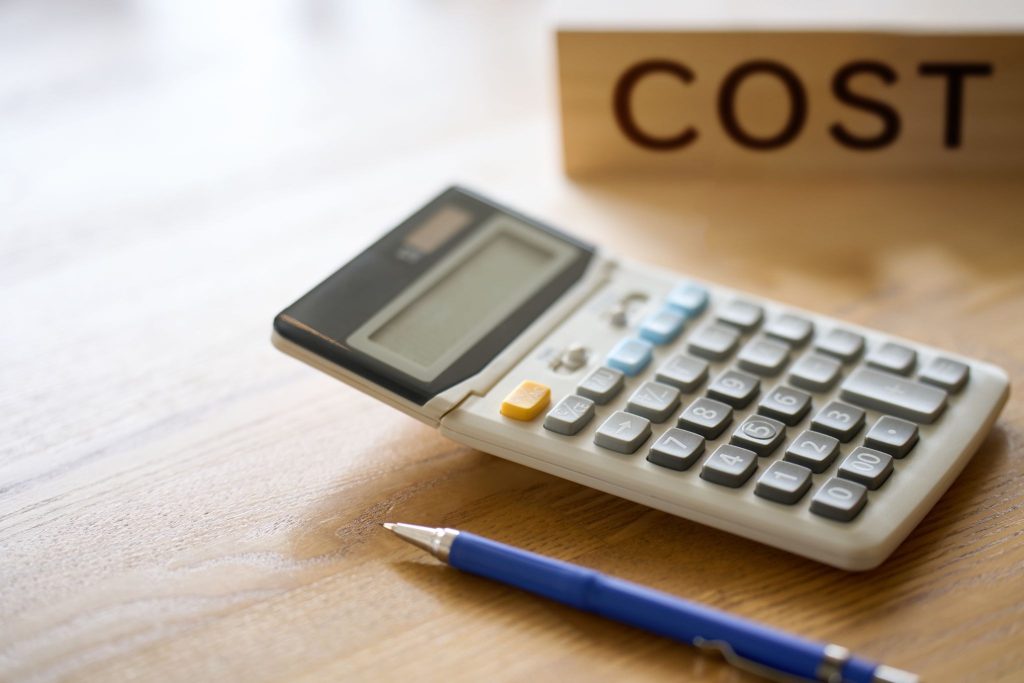 ALT TEXT: Word “cost” next to a calculator and a pencil. 